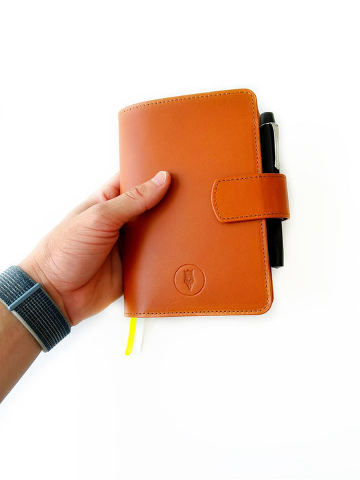 A6 leather journal cover in sunrise orange from Eng Leather Co., showcasing smooth leather with stitched edges.
