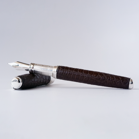Brown alligator leather fountain pen by Grifos X Papier Plume with a sleek design and gold accents.