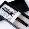 Black Grifos Papier Plume Cocodrie fountain pen with alligator leather grip and sleek design.