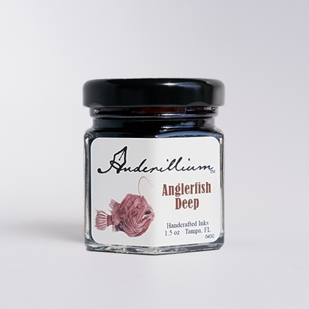 Anderillium Anglerfish Deep fountain pen ink bottle with dark, vibrant blue ink in a glass container.
