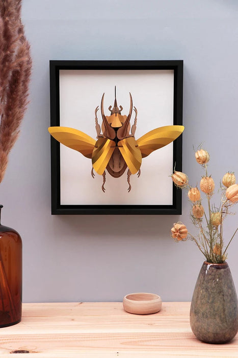 Large Paper Atlas Beetle craft by Assembli, showcasing detailed paper model with vibrant colors on a white background.
