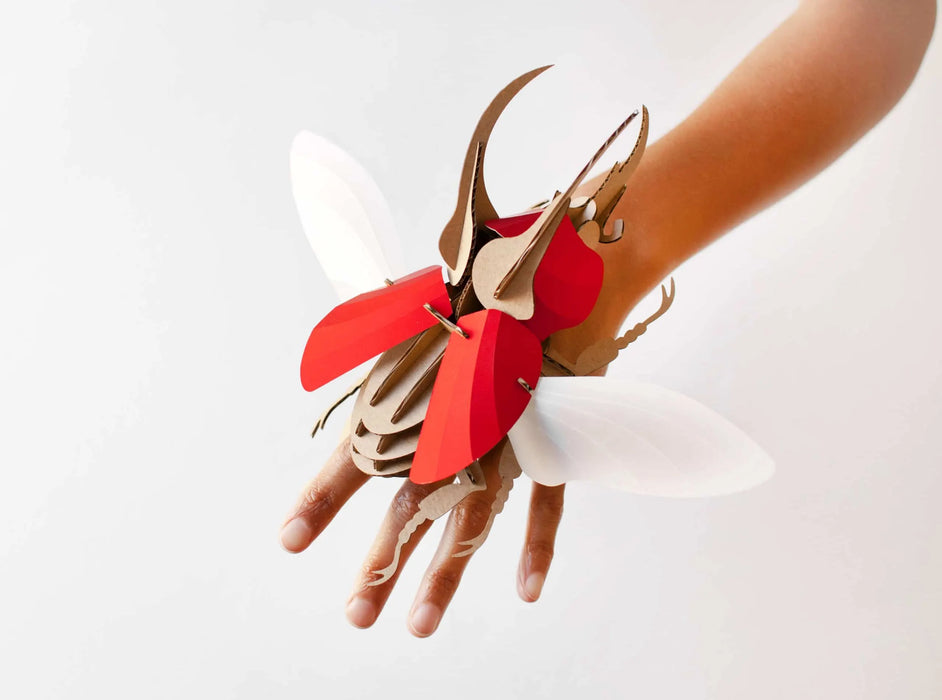 Red-scaled Paper Atlas Beetle craft by Assembli, showcasing detailed, colorful paper art with intricate beetle features.
