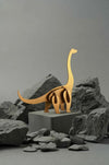 Gold paper Brachiosaurus craft by Assembli, featuring intricate origami dinosaur with detailed folds and a sleek metallic finish.