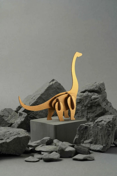 Gold paper Brachiosaurus craft by Assembli, featuring intricate origami dinosaur with detailed folds and a sleek metallic finish.