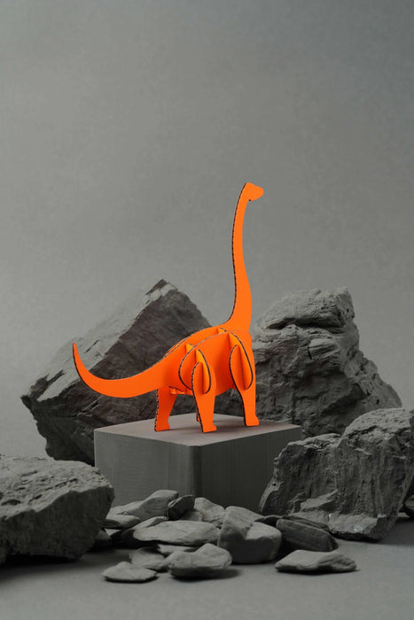 Orange paper Brachiosaurus craft by Assembli, showcasing a detailed dinosaur model made from folded paper.