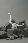 Silver-scaled paper Brachiosaurus craft by Assembli, showcasing a detailed dinosaur model made from paper materials.