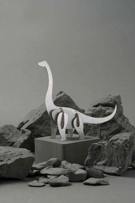 Silver-scaled paper Brachiosaurus craft by Assembli, showcasing a detailed dinosaur model made from paper materials.