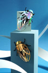 Assembli Paper Cicada craft duo with detailed paper cicada models on a neutral background.