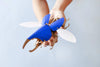 Blue Paper Hercules Beetle craft by Assembli, featuring detailed wings and body with vibrant blue paper, perfect for DIY projects.