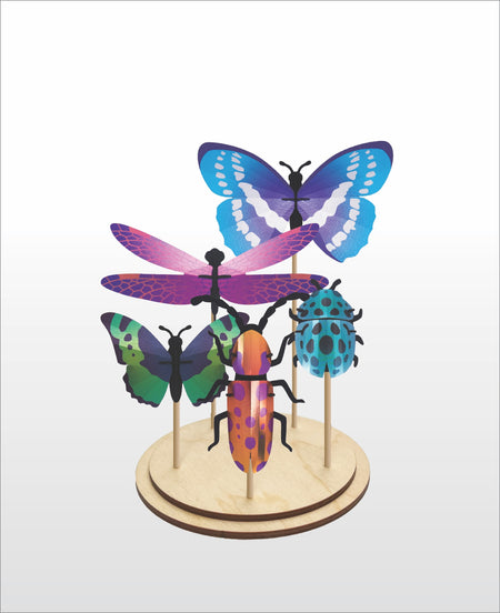 Assembli DIY craft set display featuring a purple insect combi model on a stand.