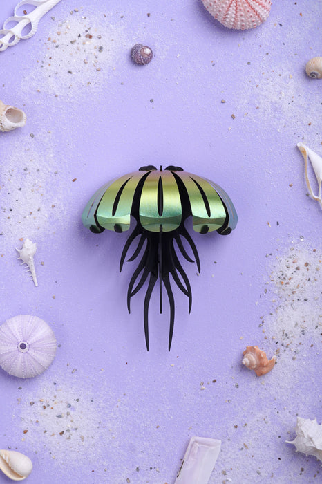 Colorful paper jellyfish craft by Assembli with yellow and orange tissue paper, displayed from a top-down view.