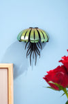 Colorful paper jellyfish craft from Assembli with orange and yellow tissue paper, designed for wall decoration or DIY projects.