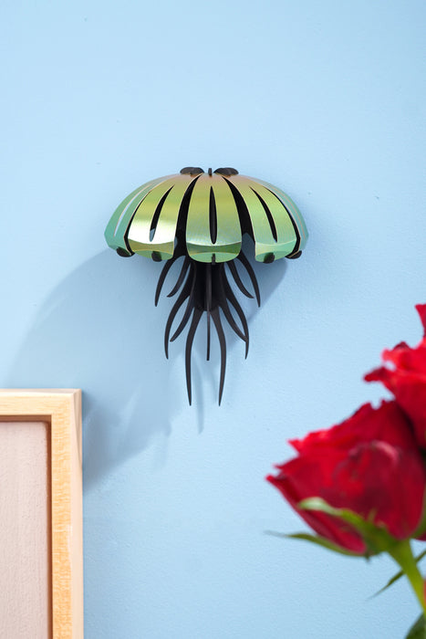 Colorful paper jellyfish craft from Assembli with orange and yellow tissue paper, designed for wall decoration or DIY projects.