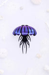Purple paper jellyfish craft by Assembli with paper tentacles and body, perfect for creative DIY projects.