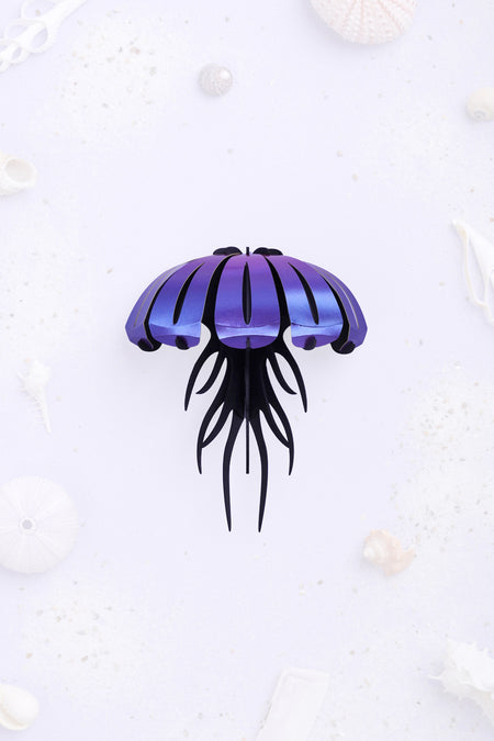 Purple paper jellyfish craft by Assembli with paper tentacles and body, perfect for creative DIY projects.