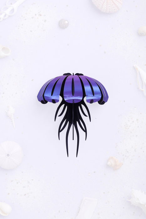 Purple paper jellyfish craft by Assembli with paper tentacles and body, perfect for creative DIY projects.