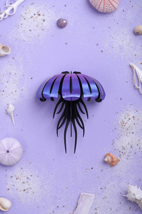Purple Paper Jellyfish craft by Assembli, viewed from above, showing textured paper and detailed tentacle design.