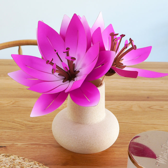 Pink paper flowers for crafts, featuring assembled paper blossoms by Assembli, arranged in a square format for creative projects.