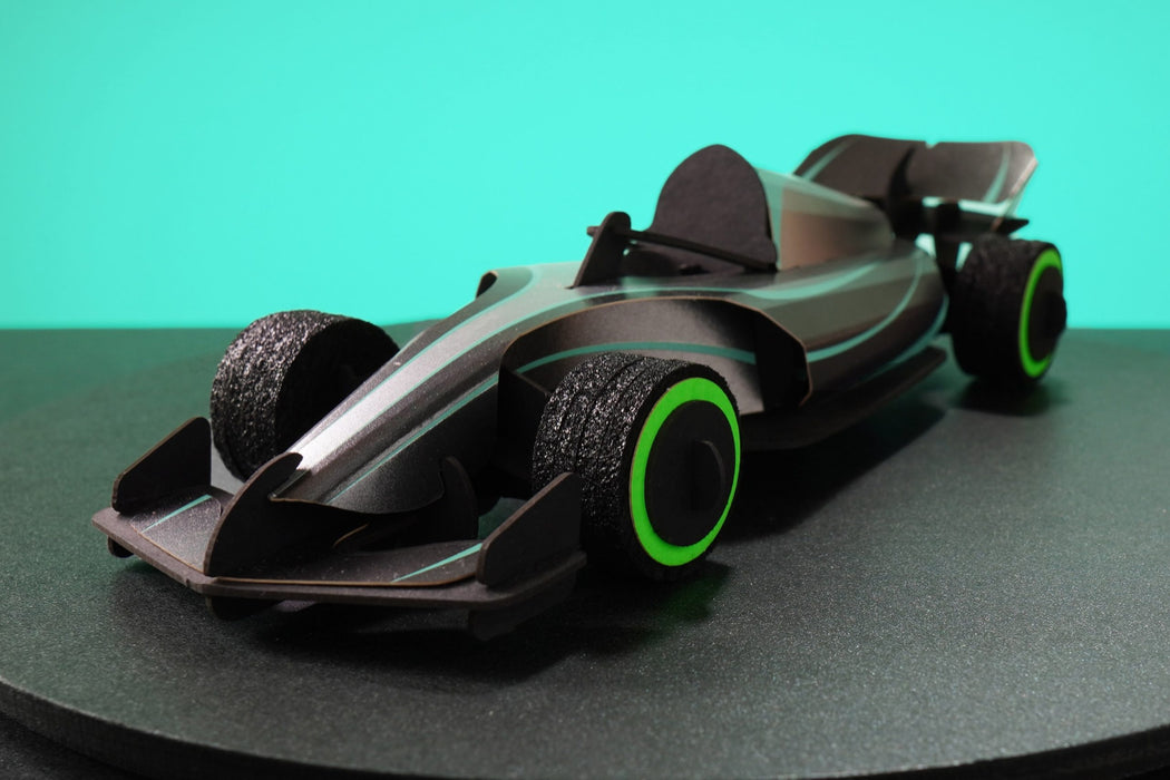 Assembli paper race car craft in carbon silver color, front view showing detailed design and sleek racing shape.