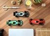 Assembli paper race car craft on a desk, featuring colorful paper components and a sleek racing design for creative projects.