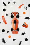 Assembli paper race car craft with flaming orange parts, showcasing assembled paper vehicle with detailed design and vibrant colors.