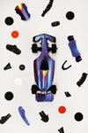 Assembli paper race car craft with blue and orange parts, assembled for a fun DIY racing project.