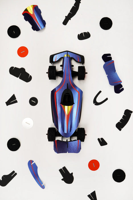 Assembli paper race car craft with blue and orange parts, assembled for a fun DIY racing project.