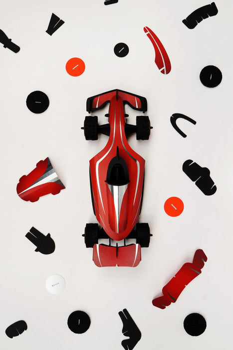 Red paper race car craft by Assembli with assembled hot parts, showcasing detailed paper car construction.