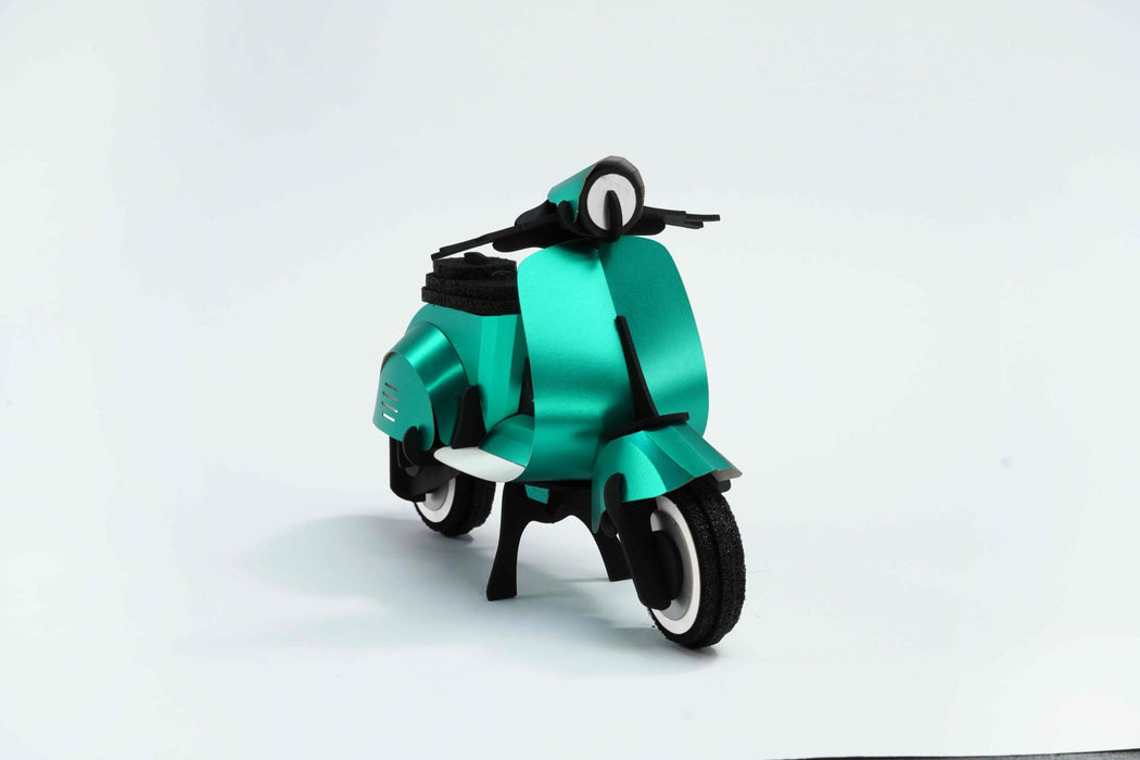 Green vintage paper scooter craft by Assembli, featuring detailed paper model with front view.