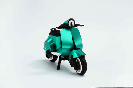 Green vintage paper scooter craft by Assembli, featuring detailed paper model with front view.