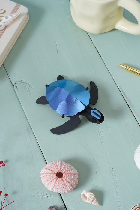 Blue Paper Sea Turtle baby craft made by Assembli, showcasing a detailed crafted sea turtle with intricate paper design.