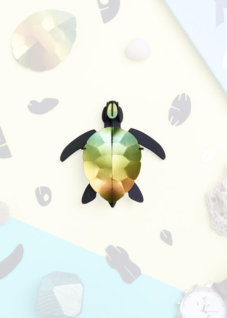 Craft paper sea turtle baby made by Assembli, featuring colorful paper in a cute sea turtle design for arts and crafts projects.