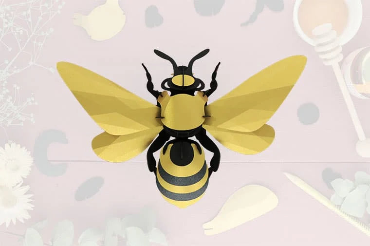 Large paper honey bee craft by Assembli featuring detailed yellow and black wings and body for creative crafting projects.