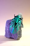 Green paper cicada craft by Assembli featuring detailed wings and body, perfect for creative DIY projects.