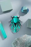 Green paper cicada craft by Assembli, showing detailed folded paper wings and body, perfect for DIY craft projects.