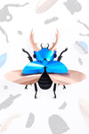 Blue Paper Giant Stag Beetle by Assembli, detailed paper craft model with intricate features and realistic stag beetle appearance.