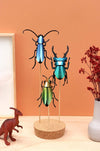Paper Rosalia beetle craft by Assembli, featuring detailed, colorful insect design on textured paper background.