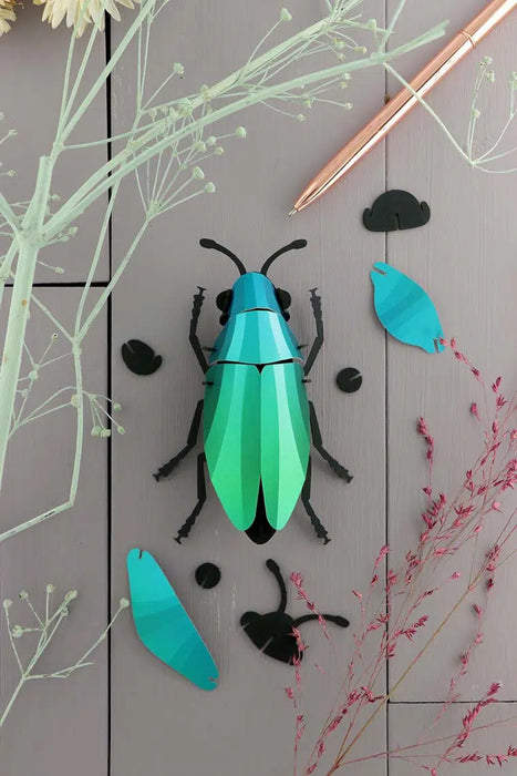 Assembli Paper Jewel Beetle craft made of green paper with detailed wing and body design, perfect for creative projects.