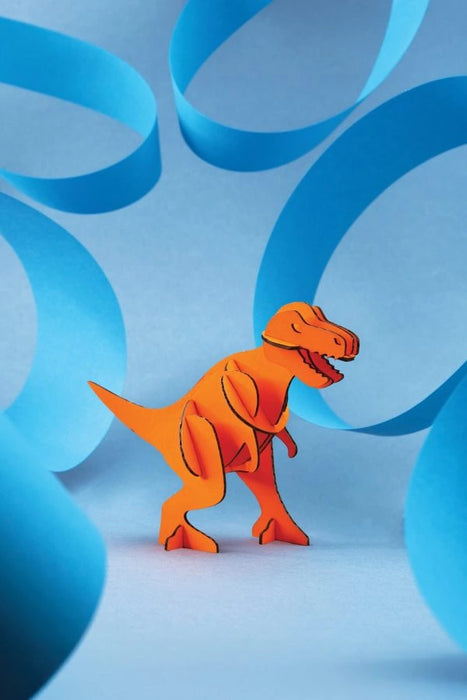 Orange paper T-Rex craft by Assembli, showcasing a detailed mini Tyrannosaurus dinosaur model for creative projects.