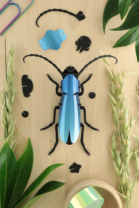 Blue Paper Rosalia Beetle craft made by Assembli, showcasing detailed paper art with vibrant blue and intricate wing patterns.