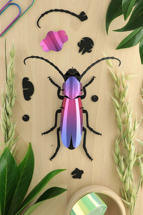 Purple Paper Rosalia Beetle craft by Assembli, showcasing detailed paper sculpture with vibrant purple wings and intricate body features.