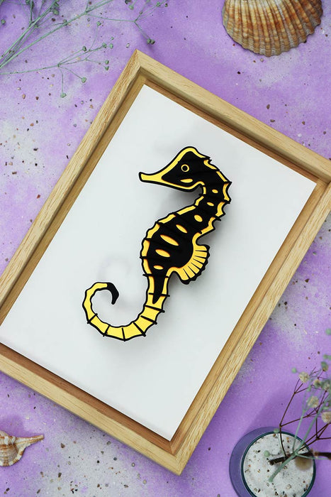 Gold seahorse craft in natural wooden frame from Assembli, showcasing detailed craftsmanship and rustic wooden texture.