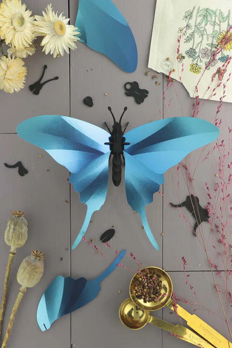 Blue Paper Swordtail Butterfly craft by Assembli featuring detailed, colorful paper wings and a realistic swordtail butterfly design.