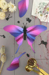 Purple Paper Swordtail Butterfly craft by Assembli, featuring detailed wing designs on a flat paper cutout.