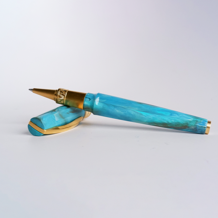Visconti Mirage Mythos Athena rollerball pen with detailed gold and blue design, elegant writing instrument on a white background.