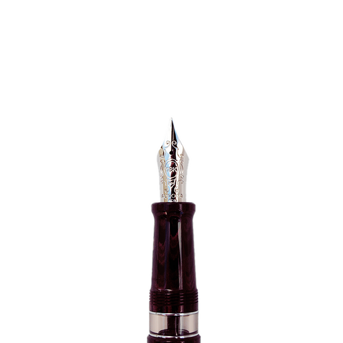 Aurora Ebonite Magenta fountain pen with gold accents, showcasing its sleek design and vibrant color on a white background.
