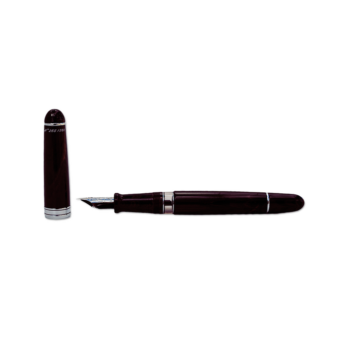 Aurora Ebonite Magenta fountain pen with gold accents, showcasing its smooth body and elegant writing tip.