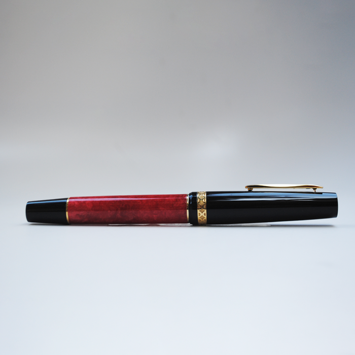 Gioia Rossa red fountain pen with gold trim, elegant writing instrument with sleek design and polished finish.