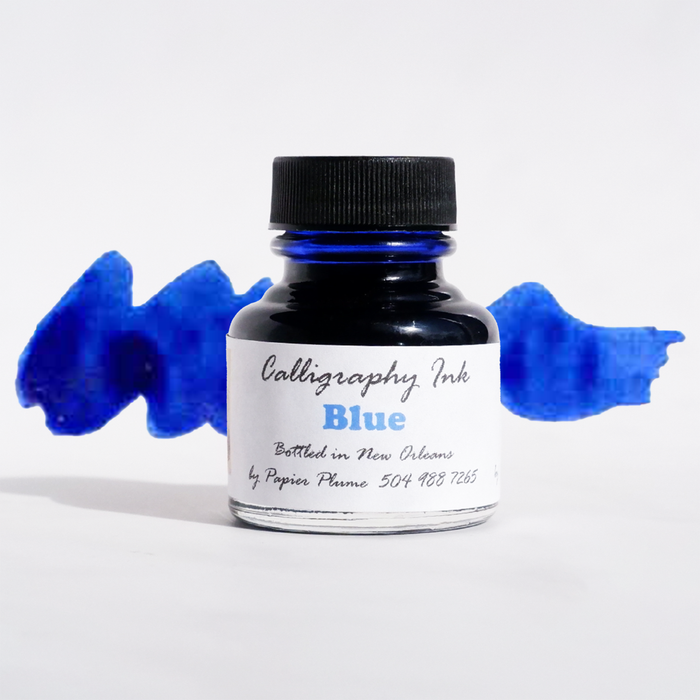 Blue bottled calligraphy ink by Papier Plume, featuring a glass bottle of vibrant ink suitable for elegant writing and artistic calligraphy.