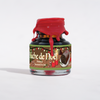 Papier Plume Bûche de Noël shimmer fountain pen ink in a glass bottle with festive packaging and colorful ink swirls.